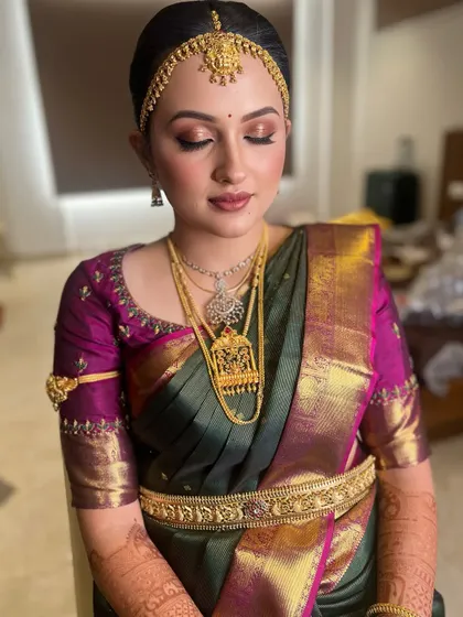 Getting this bride ready for her big day. This look features a clean, traditional hairstyle with a matha patti and soft, glowing makeup to enhance her natural features.