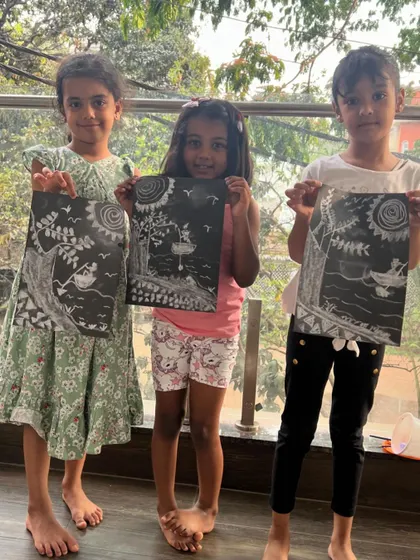 The amazing results of our chalk drawing session. The kids created these beautiful, high-contrast nature scenes on black paper.