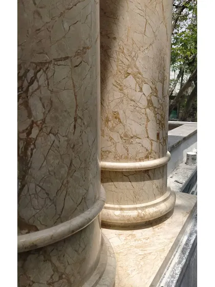 Detail is paramount in our luxury designs. Here, we used beautifully veined marble to clad these structural columns, finishing them with a classic cornice detail to elevate the entrance of a residential project.