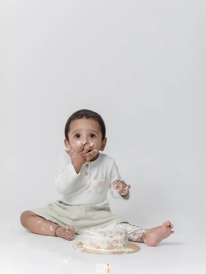 "Wasn't me!" A cute shot of the baby with frosting on his face.