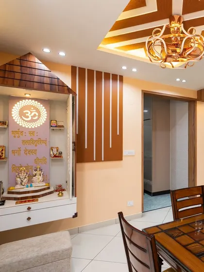 This Vastu-compliant pooja unit is designed in a traditional temple style with a wooden shikhara (roof). The Gayatri Mantra is beautifully inscribed on the back panel.