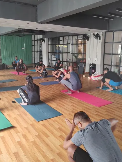 A moment from our headstand workshop, with everyone practicing Malasana (yogi squat) to prepare the hips.