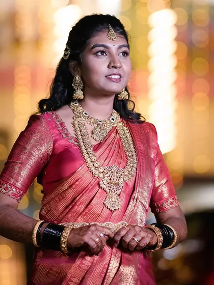 I styled this bride for her reception in a stunning traditional temple jewellery set. The layered necklaces and matching earrings in an antique gold finish perfectly complemented her beautiful pink silk saree.
