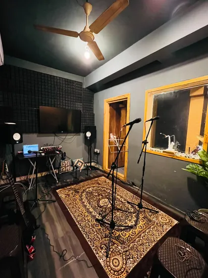 This is one of our professionally treated recording and jamming rooms. It's fully equipped with studio monitors, microphones, and a comfortable setup, creating the perfect vibe for you to practice and create.
