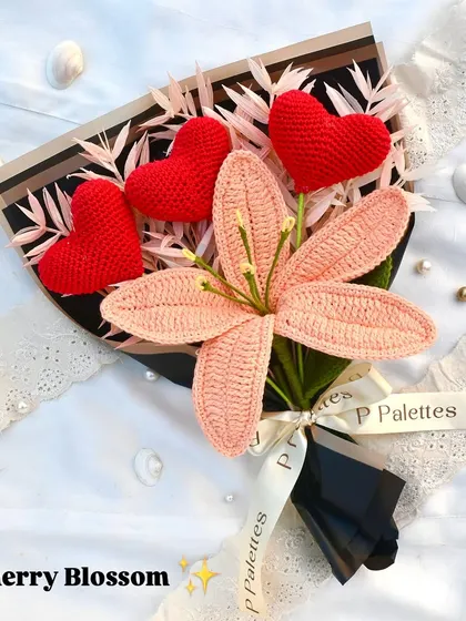 Our "Cherry Blossom" bouquet is made of poetry and flowers. It features a delicate pink lily surrounded by three crochet hearts, creating a truly romantic and artistic gift.