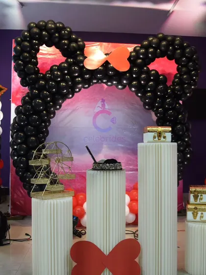 Another take on the Mickey Mouse theme, with a full balloon arch and columns in the classic red, black, and white colors.