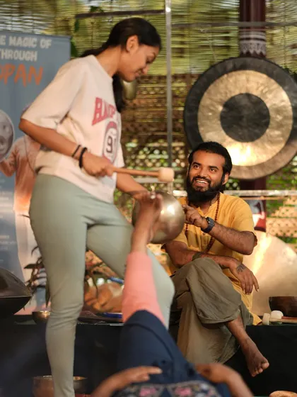 I guide a student as she performs foot reflexology with a singing bowl. My focus is on ensuring every student feels confident and skilled in these powerful, nuanced techniques.