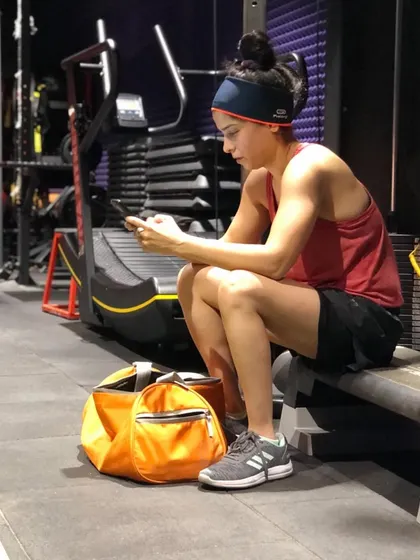 Taking a break to check messages. We understand that life doesn't stop when you're at the gym, and we've created a space where you can comfortably balance both.