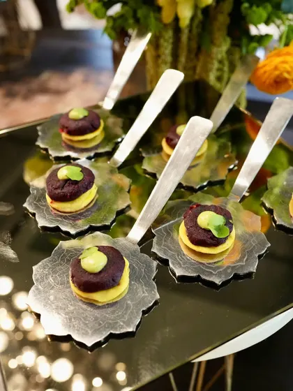 A creative appetizer served on unique, leaf-shaped spoons, demonstrating our attention to detail at the Casa Mia event.