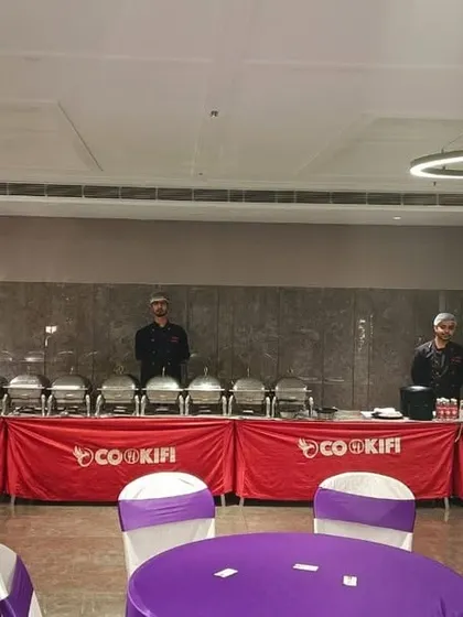 Our team ready for an evening party, with the buffet line set against the modern decor of the venue.