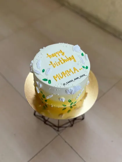 An angled view of the yellow ombre floral cake, showcasing the delicate piping work.