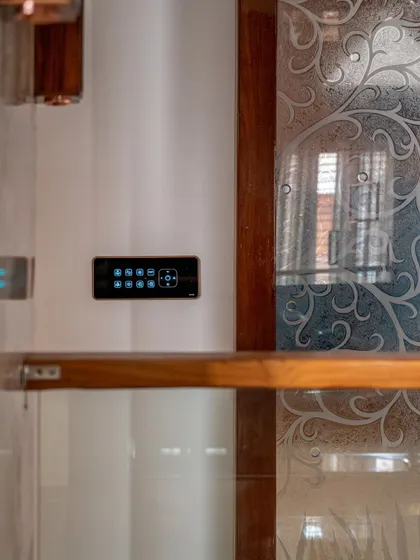 A smart panel installed next to a glass-etched door, showing how our modern tech can complement traditional design elements.