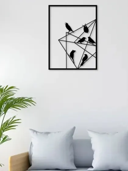 This geometric metal wall art features a flock of birds perched on abstract lines. The clean, modern design in a black finish adds a touch of nature-inspired graphic art to your living space.