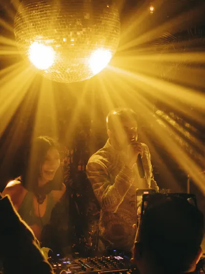 Sharing the DJ booth with a live vocalist under the golden light of a disco ball. These collaborations create unforgettable, one-of-a-kind performances.