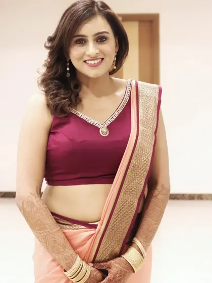 A modern and chic party look for Manisha. She is wearing a simple yet elegant saree, and her makeup is kept minimal with a focus on glowing skin and soft, wavy hair.