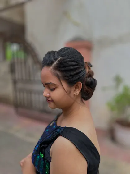 The profile view shows how the hairstyle elegantly sweeps back from the face.