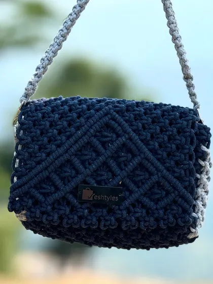 I love this color combination! A dark blue sling bag with a grey strap and sides. It's modern and very chic.