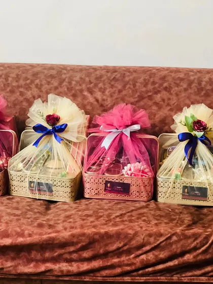 A set of four beautifully wrapped gift baskets. The different colored ribbons and net show how I can customize favors for different groups of guests or tables.