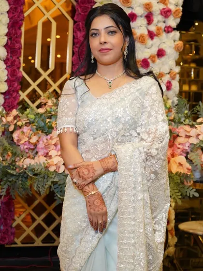 A close-up of the client against a floral backdrop.