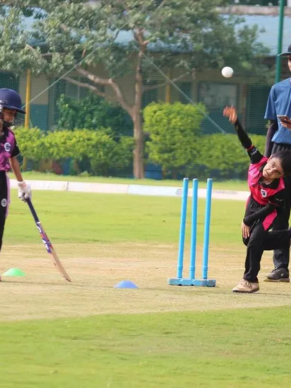 A young girl bowling during a U-10 training session, highlighting our inclusive coaching program.