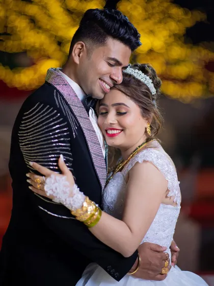 A happy and affectionate embrace between a newly married couple at their reception, capturing their post-wedding glow.