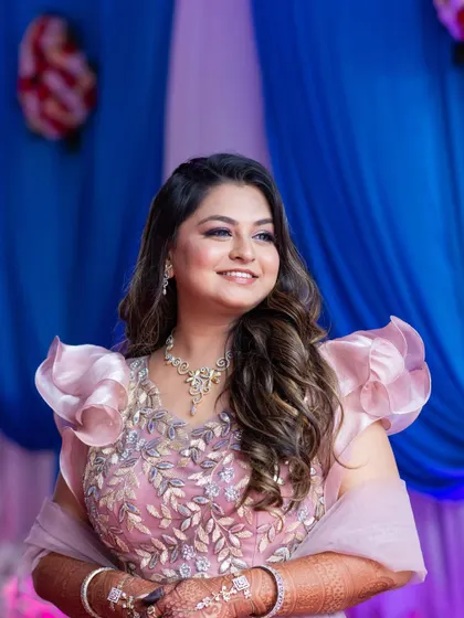 A lovely engagement ceremony look. The makeup is subtle and glowy, paired with soft open waves for a romantic and modern feel.