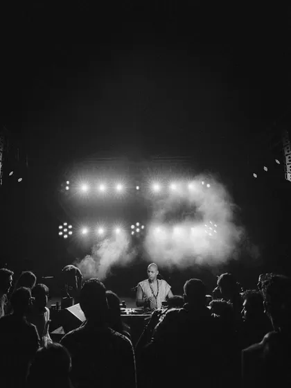 A black and white shot capturing the high-energy vibe of the DJ set. The dramatic lighting and smoke effects created a true nightclub atmosphere in the heart of the desert.