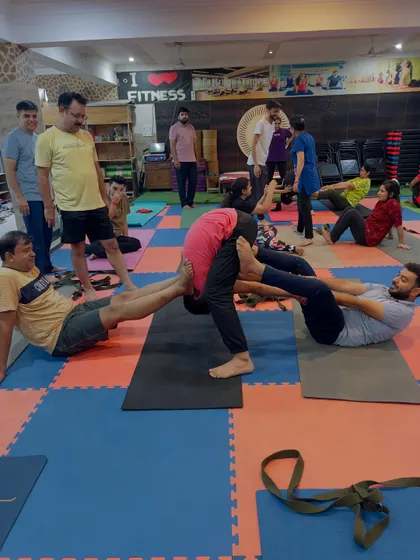 A full view of our partner stretching class. You can see the energy and connection as students help each other move deeper into the postures.