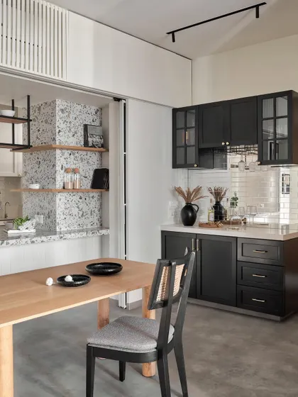 Set next to the kitchen, this compact bar commands attention with its striking beveled mirror backsplash. Under-counter storage and wall cabinets in a sleek black matte finish add both style and functionality for entertaining.