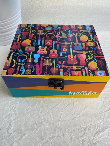 This personalized organizer box, made for 'Mallika', features a fun and colorful musical instrument theme. It's a perfect gift for any music lover.