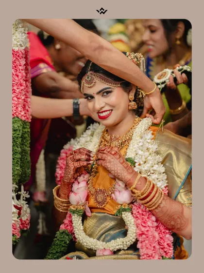 A beautiful portrait of the bride during her Brahmin wedding ceremony, adorned with traditional jewelry and a happy smile.