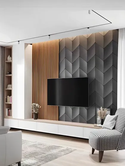 This TV unit design combines a 3D geometric accent wall with fluted wood panels. The floating white console and single armchair create a stylish, contemporary look.