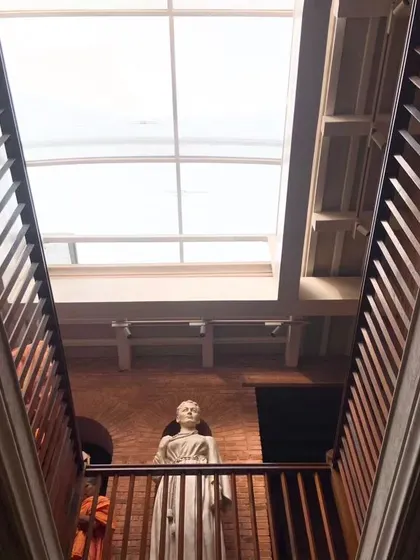 Looking up towards the skylight from the central atrium of the Sister Nivedita Museum. This addition brings natural light deep into the building, illuminating the statue of Sister Nivedita and creating a powerful focal point.