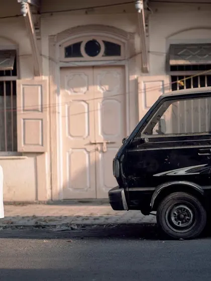 A romantic embrace in front of an old building and a classic Maruti van. This shot is full of nostalgia and old-world charm.