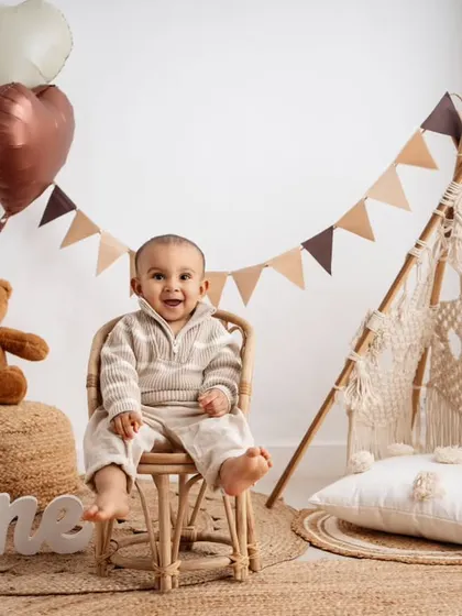 My popular boho theme, complete with a macrame teepee and natural textures, creates a warm and stylish setting for your baby's first birthday pictures.