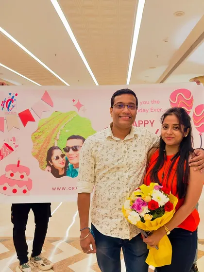 The happy couple after a successful birthday surprise in a hotel. We always end with a personalized banner and a bouquet to make the moment complete.