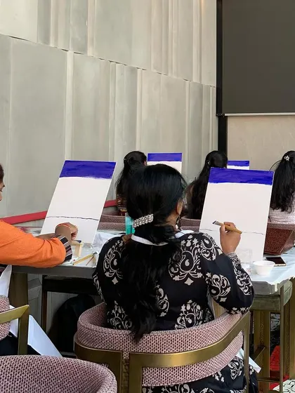 Participants at the Trio Technologies event getting started on their canvases. The beginning of every painting is a blank slate full of possibility.