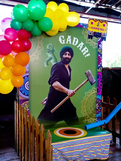 A 'Gadar' themed hammer strength game, a fun and unique take on the classic carnival high-striker for a Punjabi party.