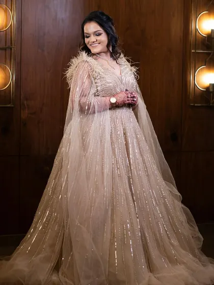 A full-length shot of the bride in her magnificent gown. The makeup is glamorous yet sophisticated.