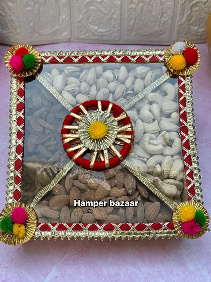 This traditional dry fruit box is a classic Diwali gift. The decorative box is filled with high-quality almonds, cashews, and pistachios, perfect for sharing with loved ones.
