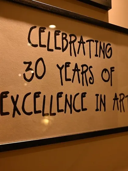 For over 30 years, I have been dedicated to fostering a love for art. This sign from our anniversary exhibition represents three decades of creativity, community, and countless masterpieces made within these walls.