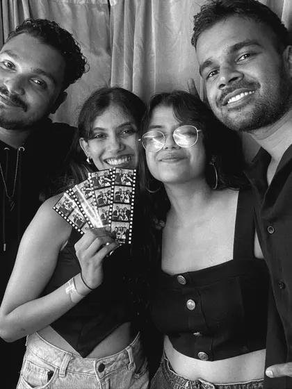 Friends posing with their photo strips, capturing the fun and casual vibe of a day at the fest.