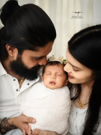 A close-up of a family's love, with mum and dad cherishing their sleeping newborn. These intimate shots are so precious.