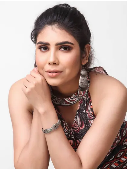 A simple, clean headshot is one of the most important photos in a model's book. This portrait captures a natural and direct look, showcasing the model's features clearly for casting purposes.
