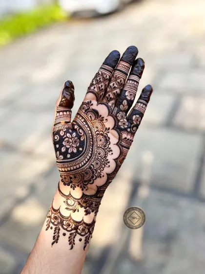 The same modern floral design, captured from a different angle. The dark, solid-filled fingertips provide a beautiful contrast to the detailed work on the palm and wrist.