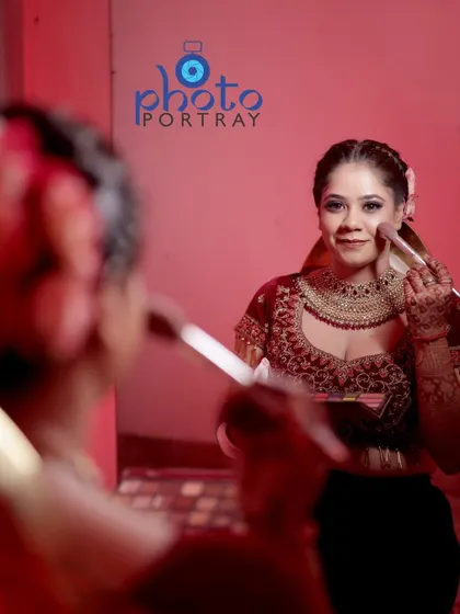 A behind-the-scenes shot of the bride getting her makeup touched up. We capture these getting-ready moments that are part of the wedding day story.