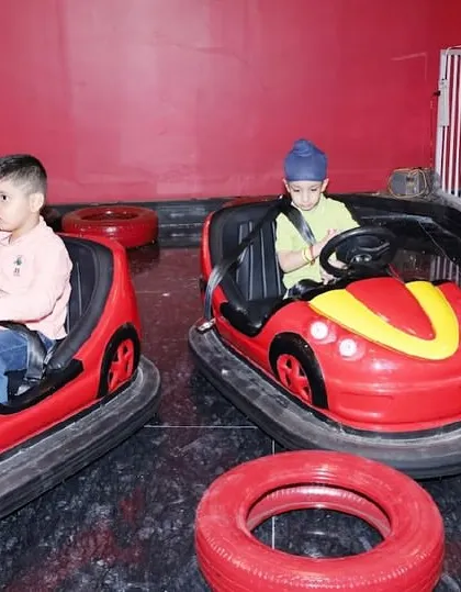 Two boys enjoying a friendly competition in our bumper car arena.