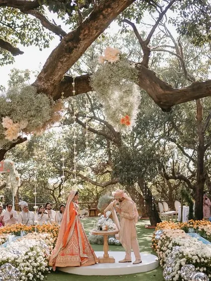 A wedding ceremony should feel like it’s floating on air. For Aashna and Armaan, we created a circular aisle enveloped by an ombré wave of thousands of roses, with baby's breath clouds hanging from the trees above. This was the setting for their sand ceremony, a beautiful symbol of two lives blending into one.