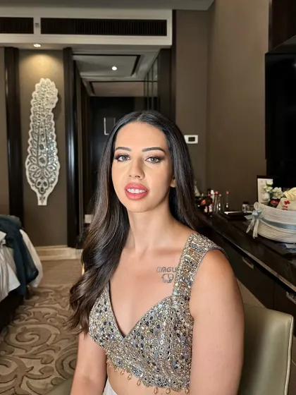 Sangeet glam for Janki. This look features a shimmering, sequined top paired with a soft smokey eye and a pink lip.