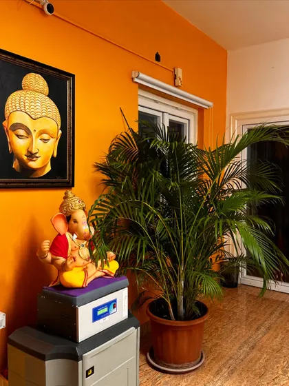 The warm and welcoming entrance to our studio, featuring vibrant orange walls and beautiful artwork.